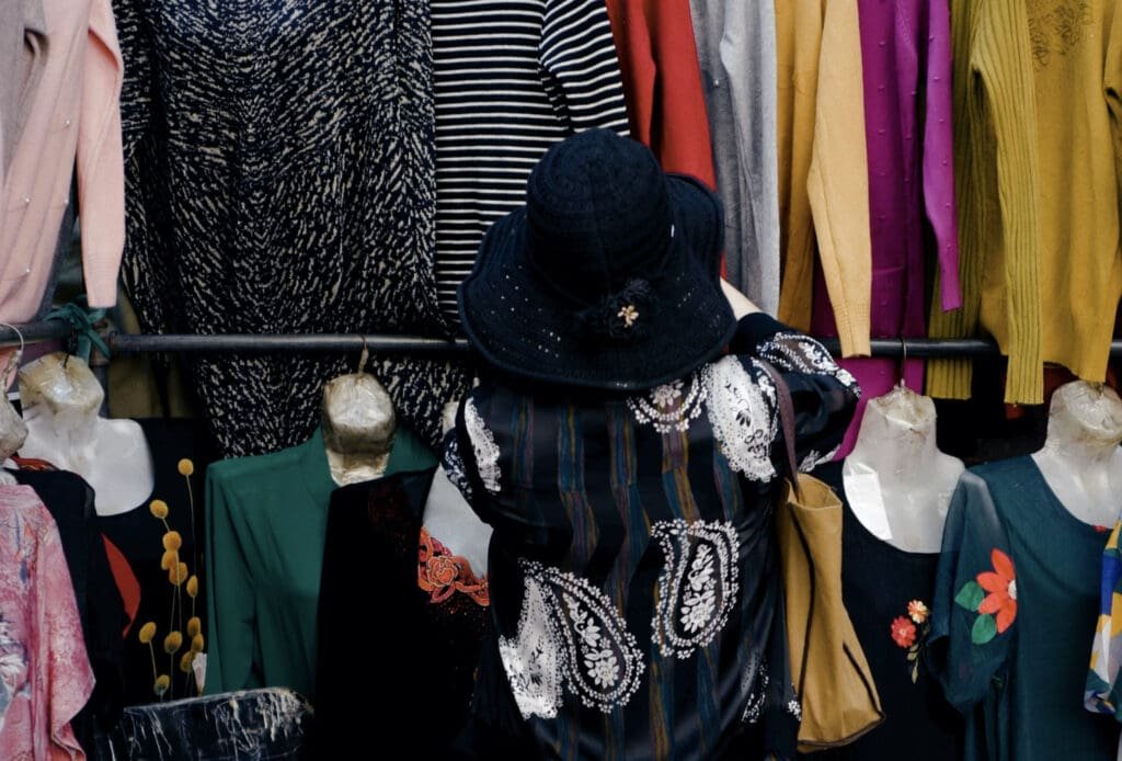 Une femme parcourant un rayon de vêtements à vendre à Sabradou.